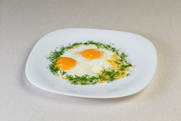 Fried eggs with greens