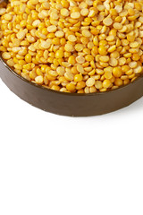 Dry yellow split peas isolated on white.