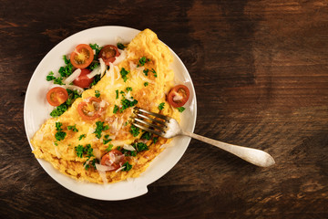 Omelette with parsley, cherry tomatoes, and copyspace