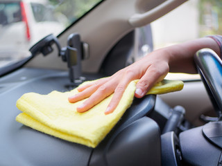 Hand cleaning interior car steering wheel with microfiber cloth