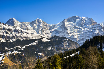 Snow capped mountain peaks of Swiss Alps on Golden Pass railway famous scenic train line from...