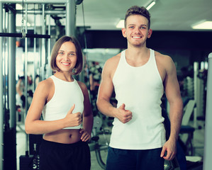 Portrait of  couple standing together in gym indoors