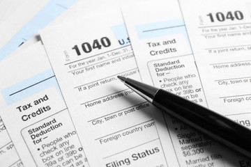 Fototapeta na wymiar Individual Tax Return Forms and pen on table
