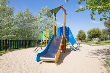 lonely metal slide in outdoor playground, in public Park Valdebebas, Madrid Spain
