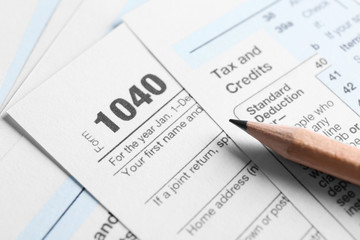 Individual Tax Return Forms and pencil on table