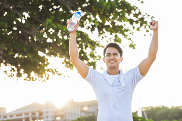 excited man raised his arm after exercising