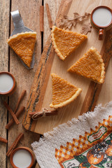 Fresh Homemade Pumpkin Pie made for Thanksgiving. Pie on a wooden background. Rustic.