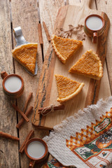 Fresh Homemade Pumpkin Pie made for Thanksgiving. Pie on a wooden background. Rustic.