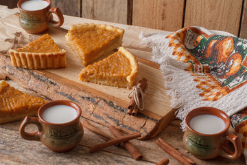 Fresh Homemade Pumpkin Pie made for Thanksgiving. Pie on a wooden background. Rustic.