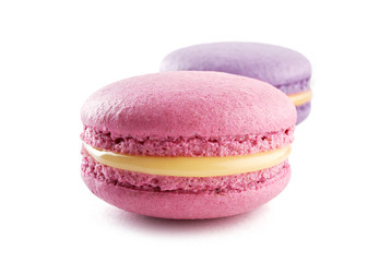 Two colorful French almond cookies macarons or macaroons isolated on white background