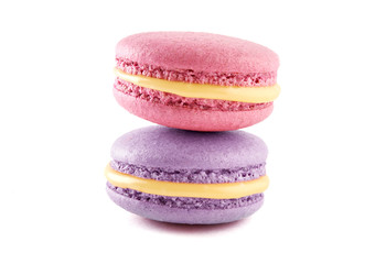 Two colorful French almond cookies macarons or macaroons isolated on white background