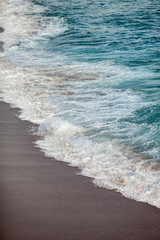Foamed waves breaking in the beach