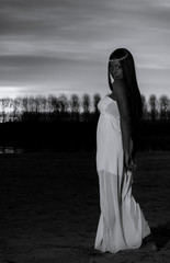 Black & White full shot of a black model in a white dress