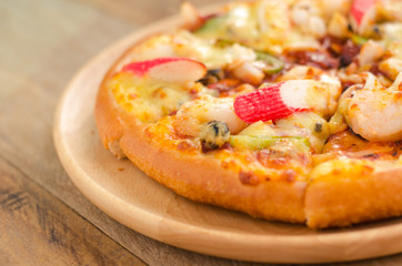 Pizza Seafood on wooden table ready to eat.