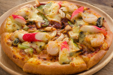 Pizza Seafood on wooden table ready to eat.