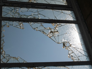 Broken frosted glass window in derelict factory