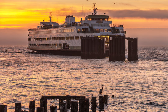 car ferry leaving dock at sunset