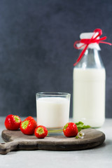 Fresh cow milk and ripe organic strawberry