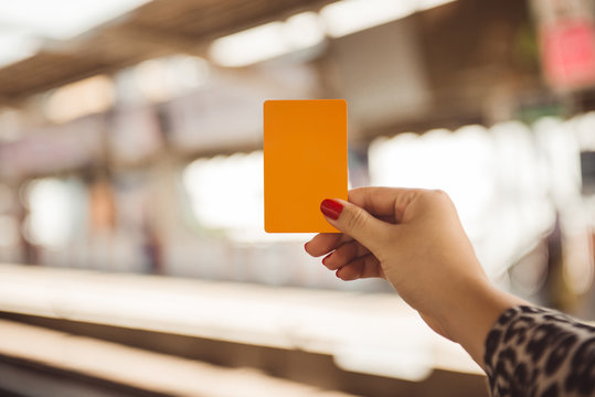 Woman Hand Holding Smartcard For Mrt Or Train On Blurred Of Train Station