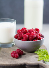 Fresh cow milk and ripe organic red raspberry