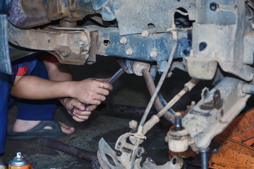 Engine repair,Mechanic working in a car under the hood,Engine repair service station.