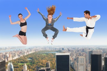 Fototapeta na wymiar Composite image of man and women jumping over white background