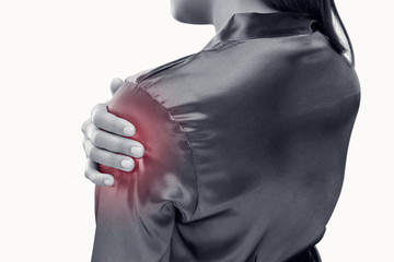 Young woman suffering from pain in shoulder