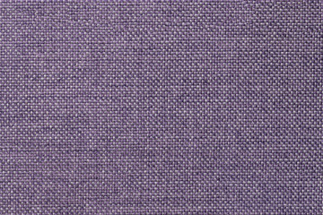 Fototapeta na wymiar Dark violet background of dense woven bagging fabric, closeup. Structure of the textile macro.