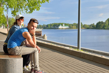 Fototapeta premium Man and woman on the bench of the embankment of the river great