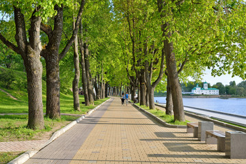 A couple of passersby on the walk of the embankment of the river great