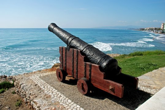 Cannon on the edge of sea with views along the beach and coastline, Torrox Costa, Spain.
