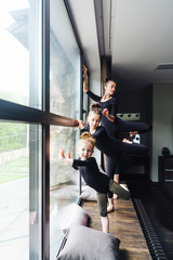 Mom and two daughters practice ballet
