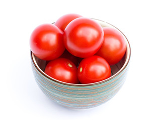tomatoes in a bowl on a white background