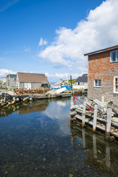 Scenic harborside view of the historic fishing village of Peggys Cove, on the maritime coast of Novia Scotia near Halifax, Canada, under bright blue sky