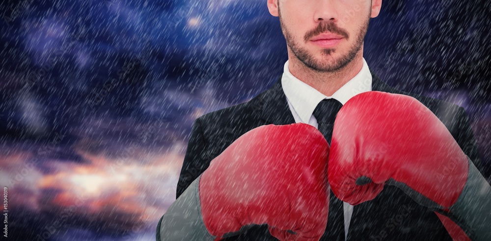 Poster Composite image of businessman with boxing gloves