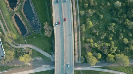 Aerial shot of a highway in the evening, top down view. 4K video