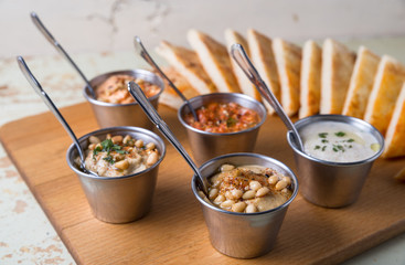 Set of appetizers: hummus, muhammara, tirokafteri, Greek cacik