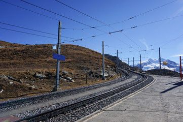 Fototapeta na wymiar Beautiful scenic train railway transportation on alp with snow mountain in daylight, Switzerland