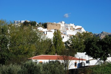 View of the village on the hill showing part of the old village wall, El Burgo, Spain. © arenaphotouk