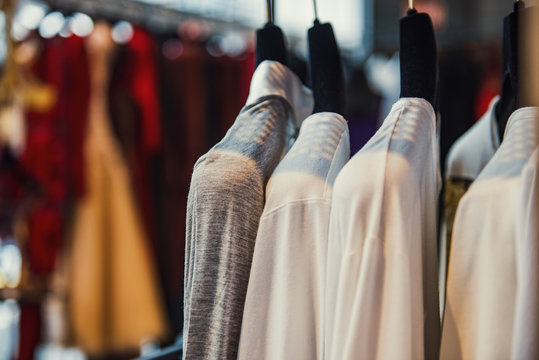Women boutique shop concept - colorful clothing on hangers.