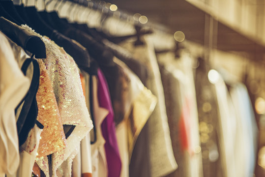 Women boutique shop concept - colorful clothing on hangers.
