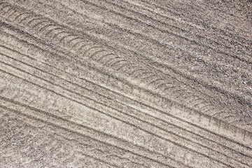 Dry sand tyre mark background.