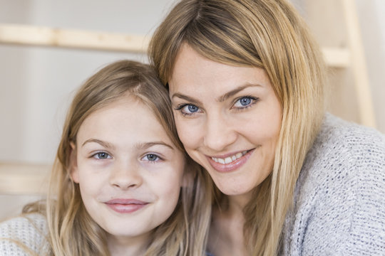 Portrait of smiling little girl with her mother