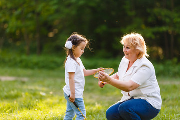 Mother and daughter playing tennis, portrait