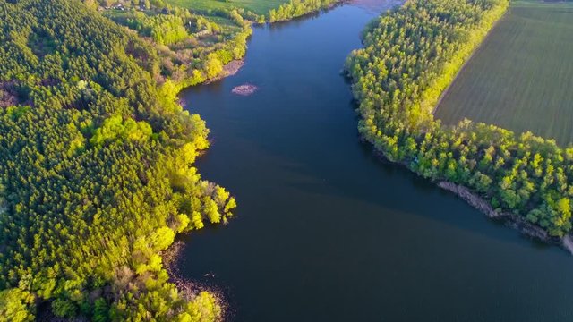 Flying over the beautiful spring river. Aerial camera shot. Ukraine.