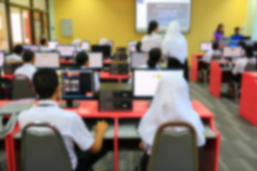 focus blur, the student with teacher learning business technology desktop computer in a classroom