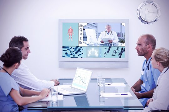 Composite image of team of doctors having a meeting