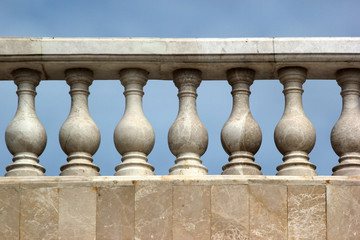 Fototapeta na wymiar Old marble balustrade on blue sky background