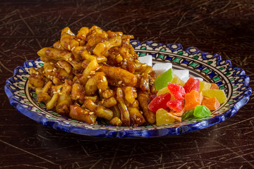 Eastern sweets, dried fruits and sugar on a traditional plate