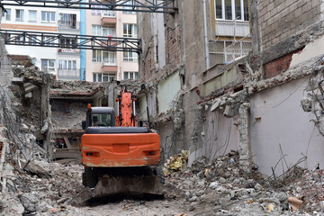 Fototapeta na wymiar Hydraulic crusher excavator machinery working on site demolition
